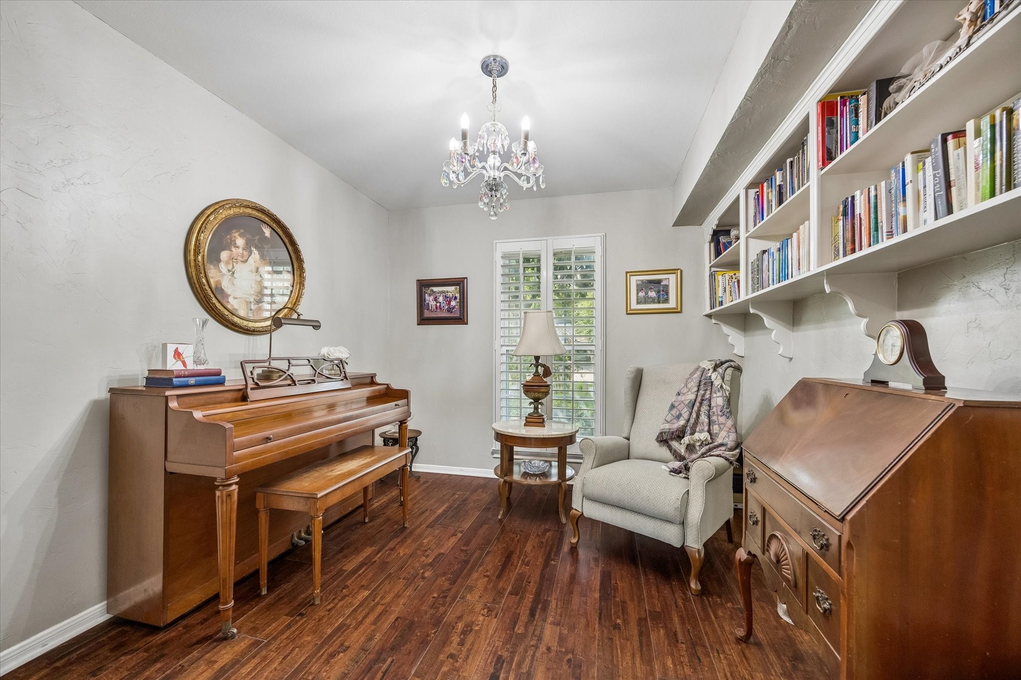 13926 Perthshire Road Houston, TX 77079 - Photo 19 of 31 Private study located just off the primary bedroom, featuring built-in bookshelves and offering a quiet retreat for reading, working or relaxing. Currently used as a piano and reading room, the space provides a charming and versatile extension of the primary suite.