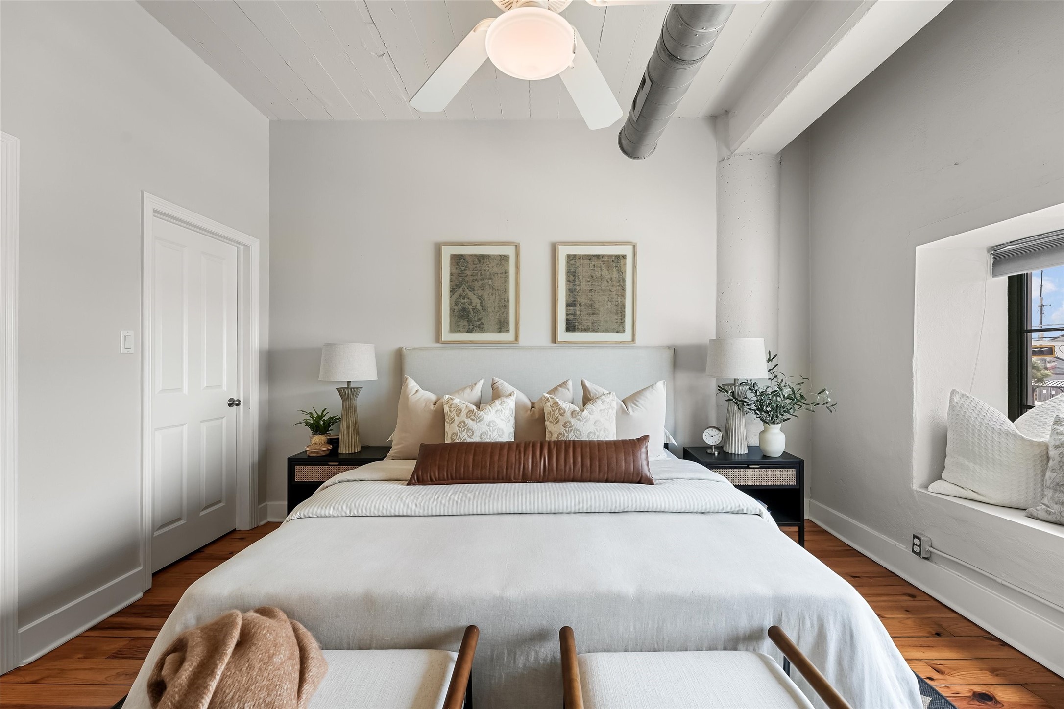 104 21st Street, Unit 203 Galveston, TX 77550 - Photo 11 of 27 a bedroom with a large bed and a chandelier