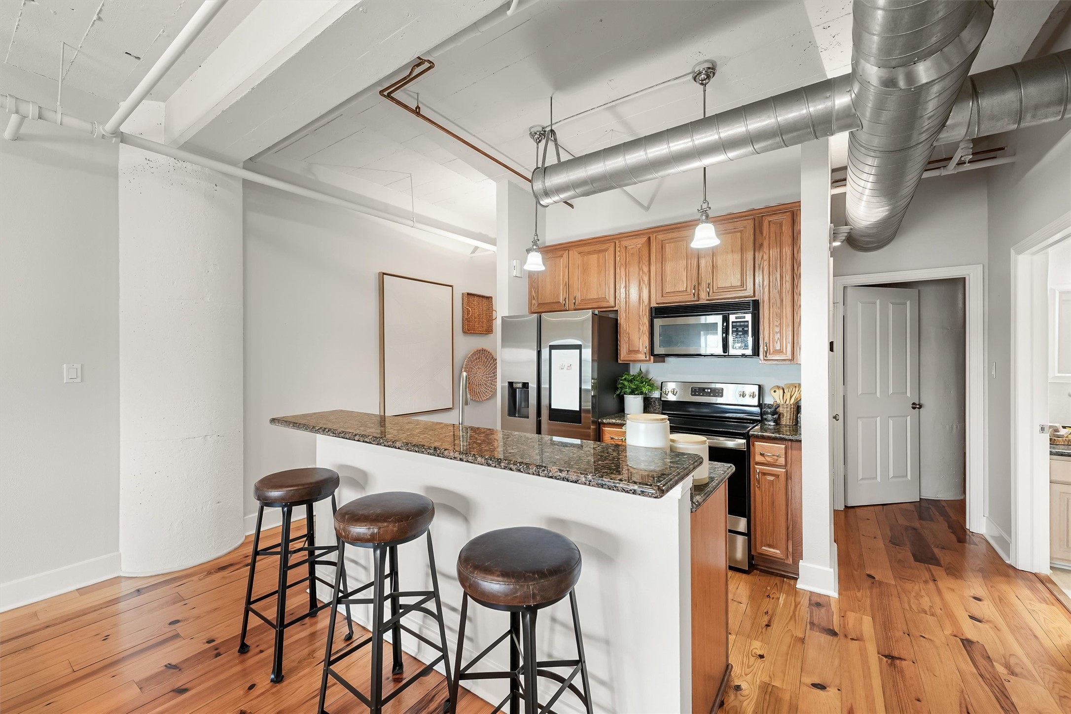 104 21st Street, Unit 203 Galveston, TX 77550 - Photo 5 of 27 a kitchen with stainless steel appliances granite countertop a stove and refrigerator