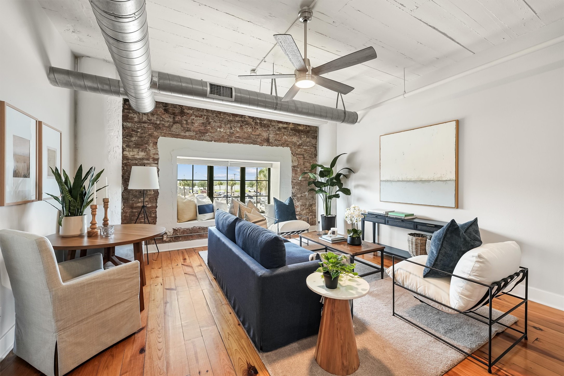 104 21st Street, Unit 203 Galveston, TX 77550 - Photo 7 of 27 a living room with furniture and a chandelier