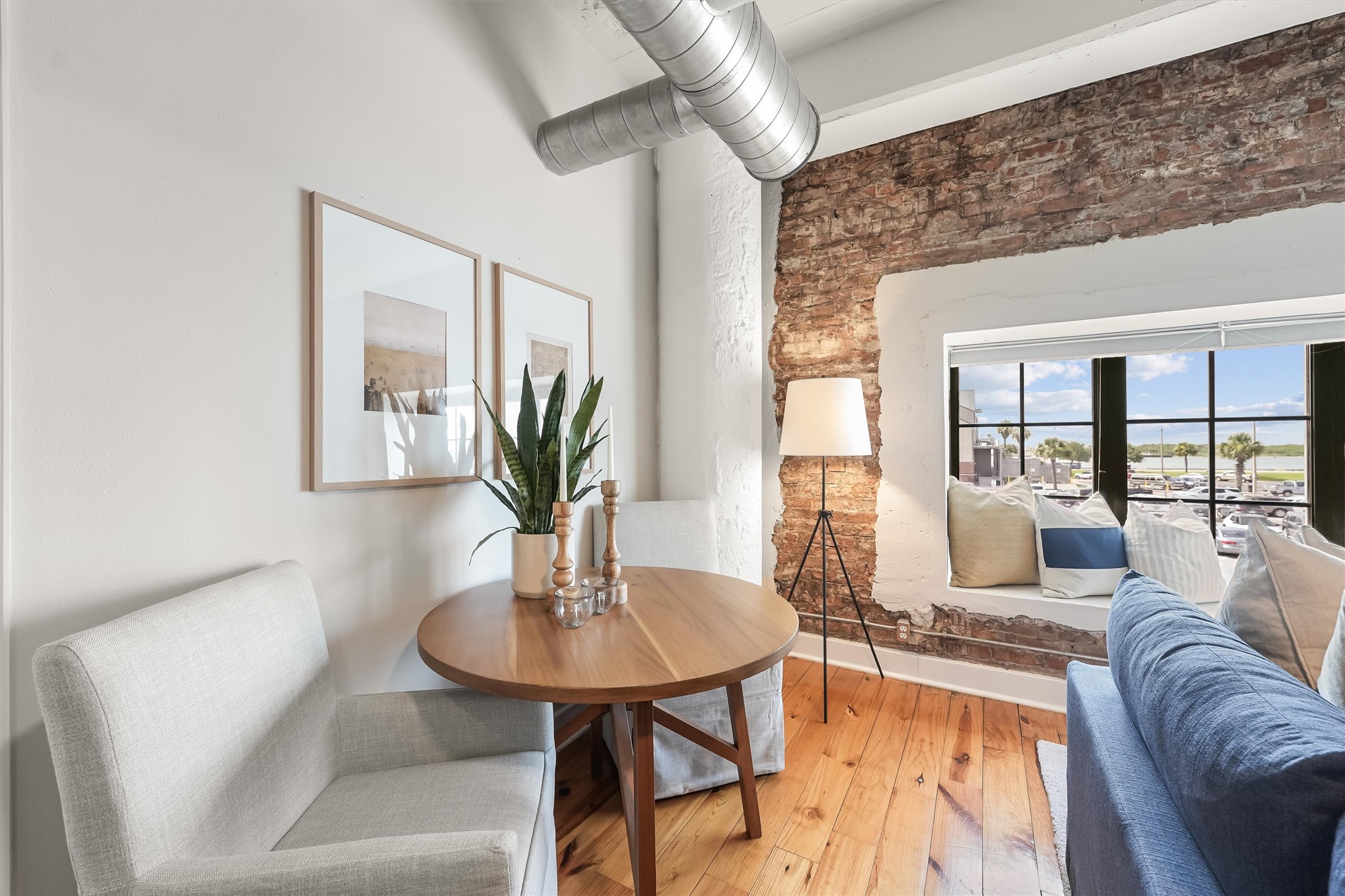 104 21st Street, Unit 203 Galveston, TX 77550 - Photo 9 of 27 a living room with furniture and a table