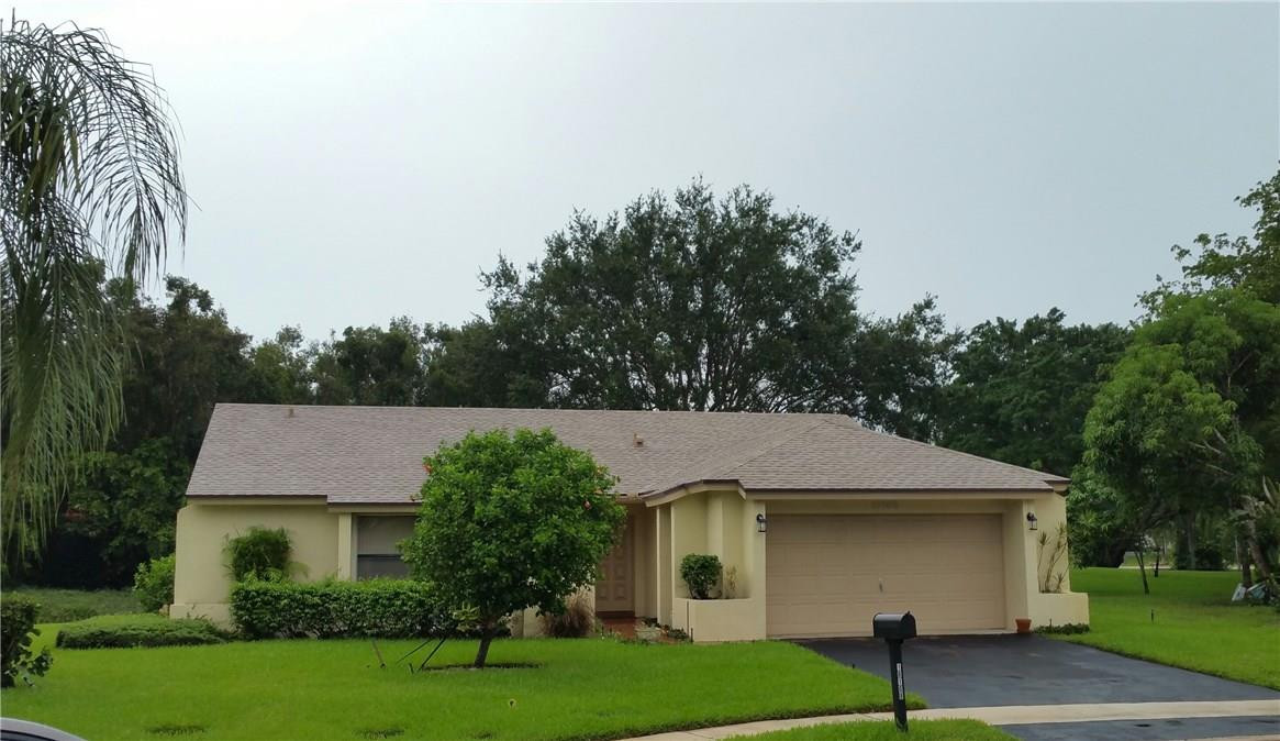 18108 102nd Way South Boca Raton, FL 33498 - Photo 1 of 21 a front view of a house with a yard and garage