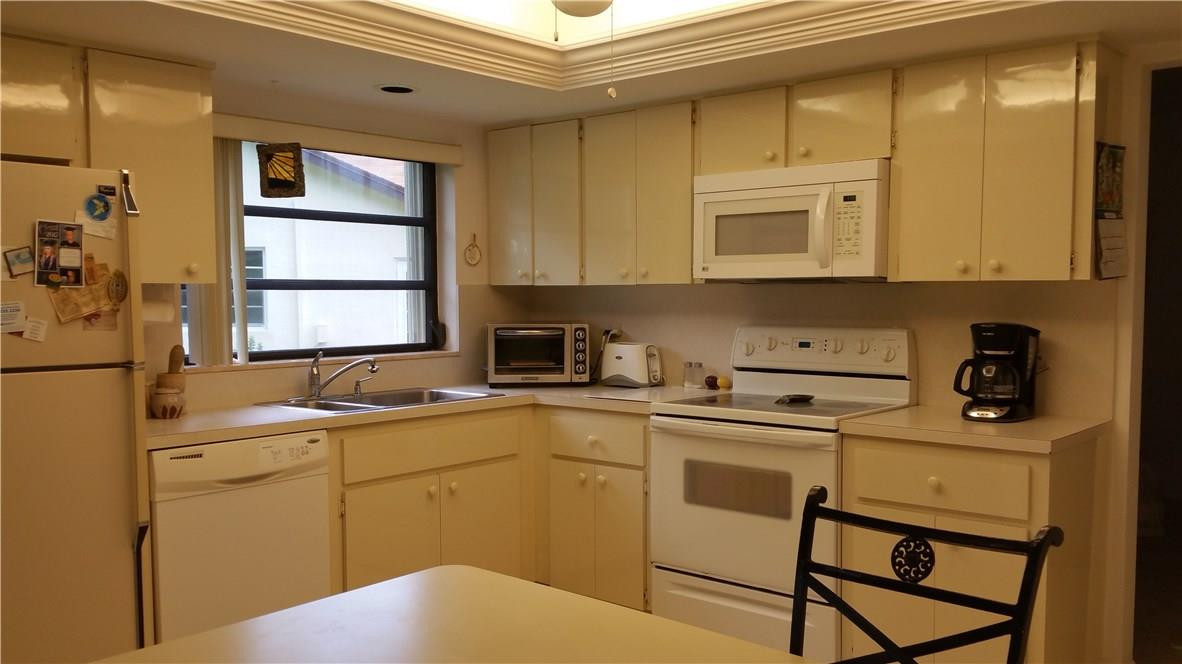 18108 102nd Way South Boca Raton, FL 33498 - Photo 13 of 21 a kitchen with a sink cabinets and window