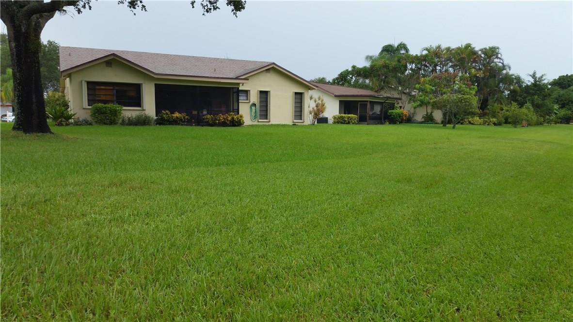 18108 102nd Way South Boca Raton, FL 33498 - Photo 17 of 21 a front view of house with yard and green space