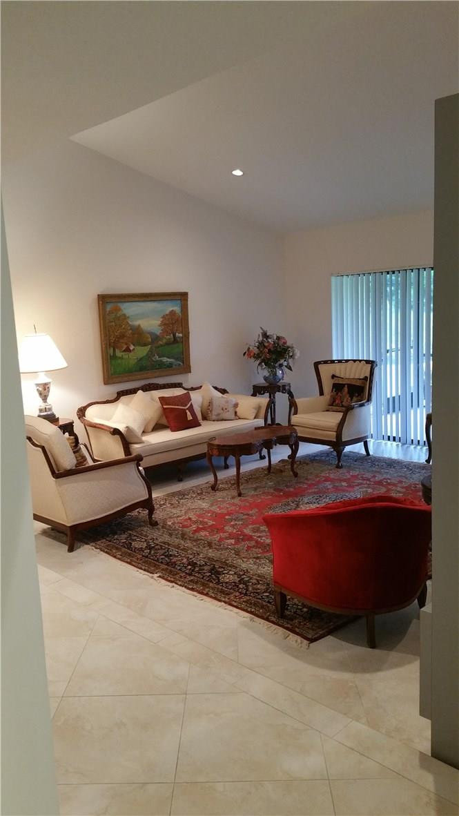 18108 102nd Way South Boca Raton, FL 33498 - Photo 4 of 21 a living room with furniture and a fireplace