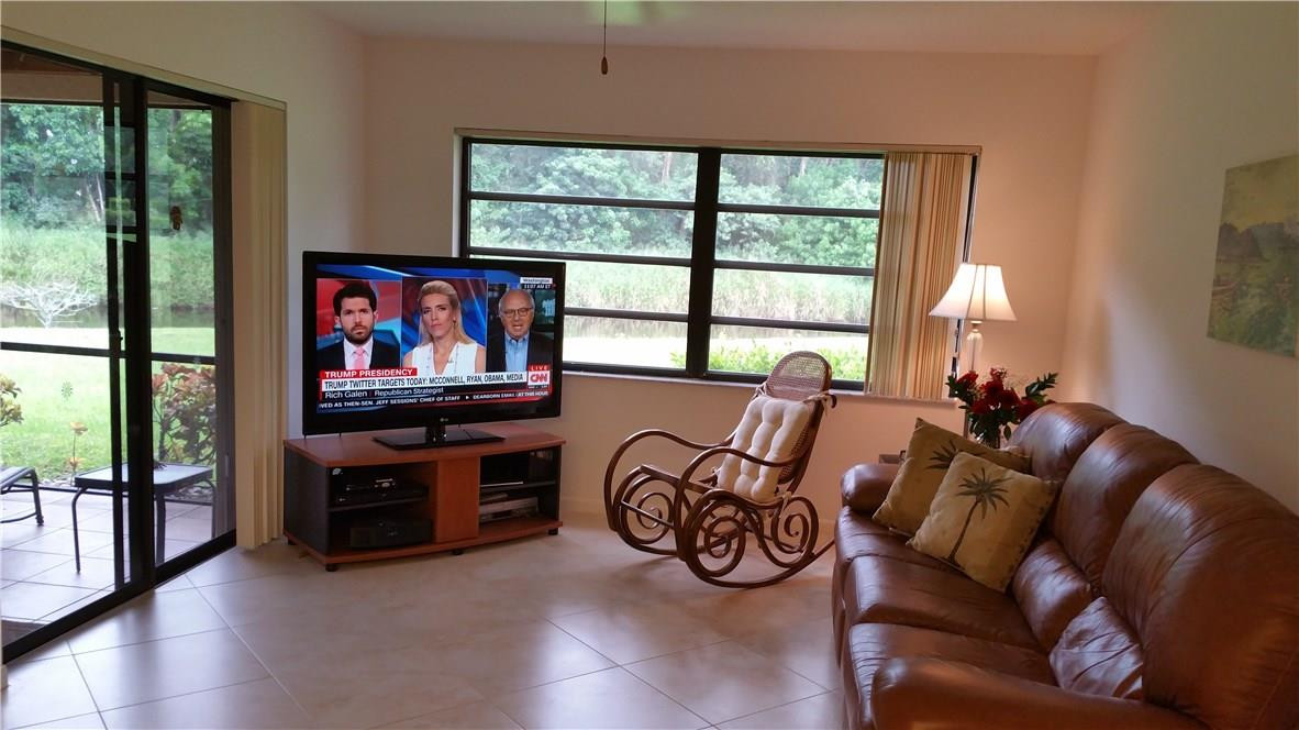 18108 102nd Way South Boca Raton, FL 33498 - Photo 6 of 21 a living room with furniture a flat screen tv and a large window