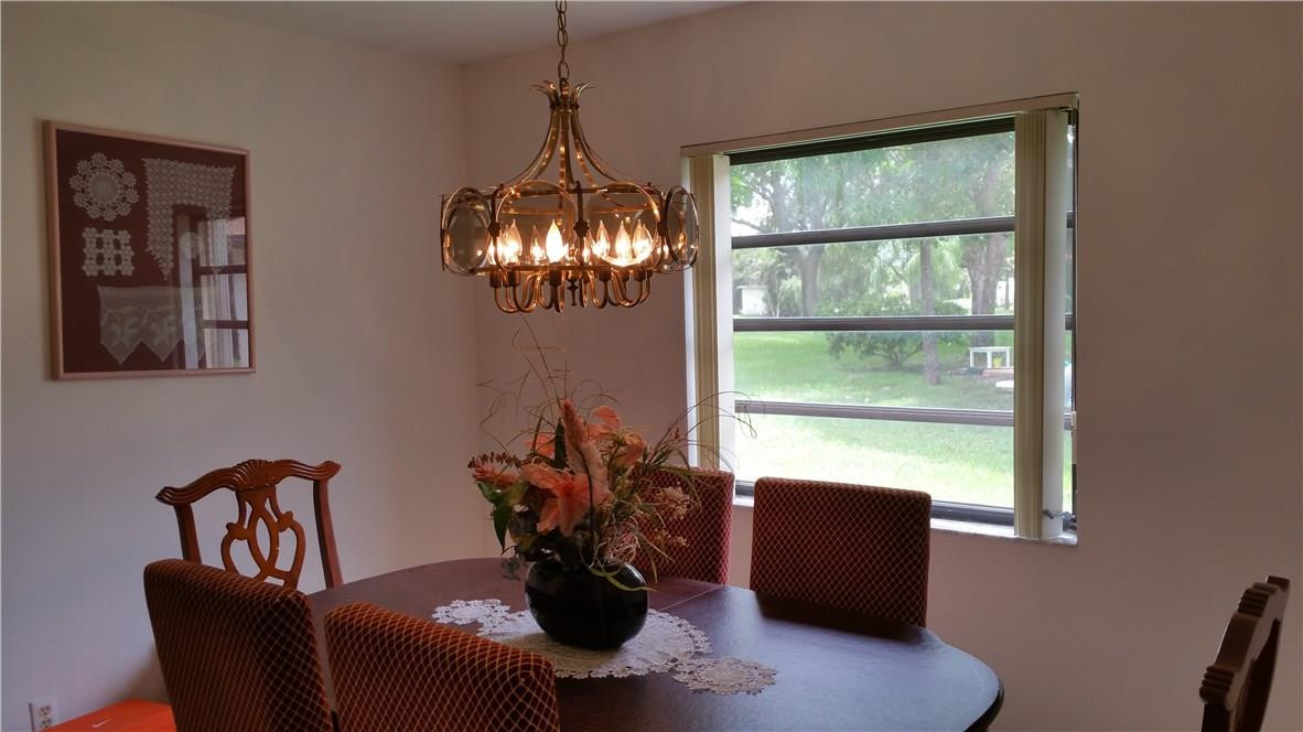 18108 102nd Way South Boca Raton, FL 33498 - Photo 8 of 21 a view of a dining room with furniture window and outside view