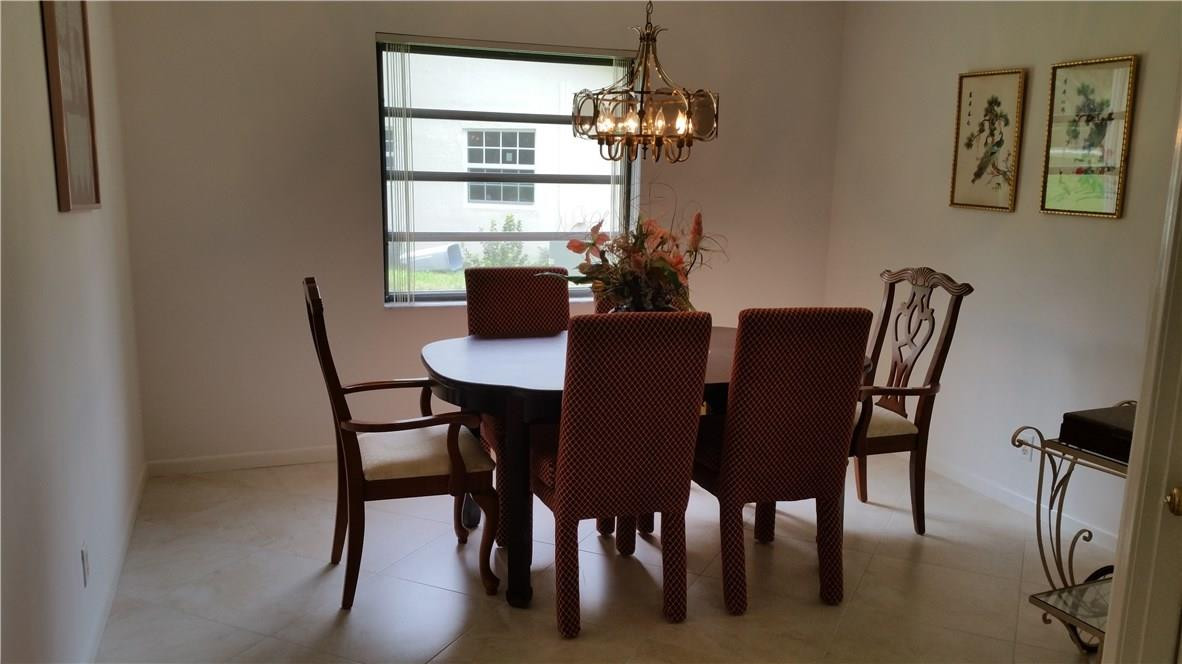 18108 102nd Way South Boca Raton, FL 33498 - Photo 9 of 21 a view of a dining room with furniture and window