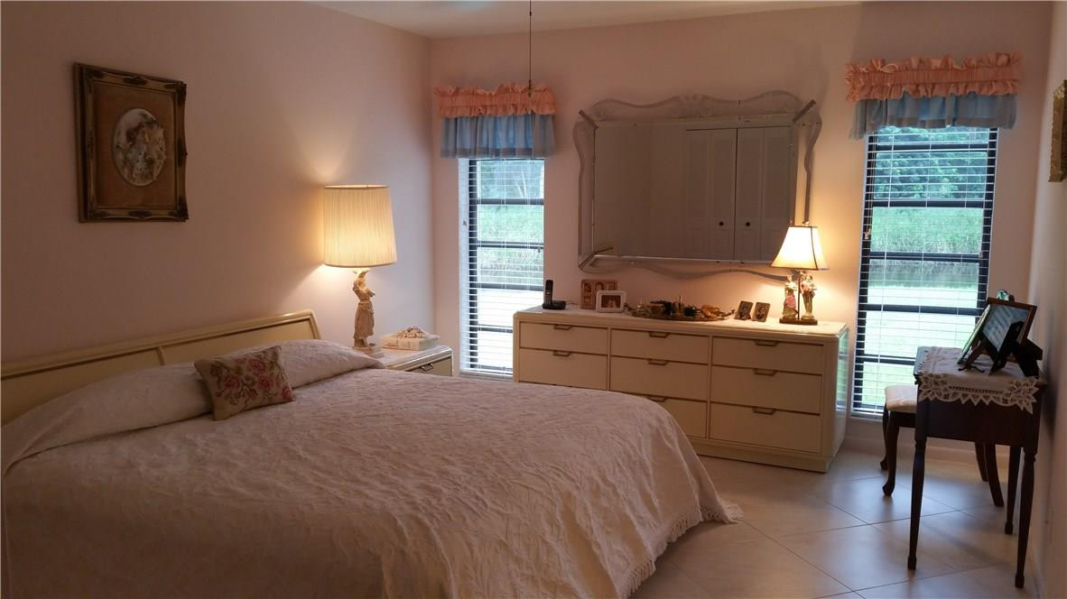 18108 102nd Way South Boca Raton, FL 33498 - Photo 10 of 21 a bedroom with a bed and a window