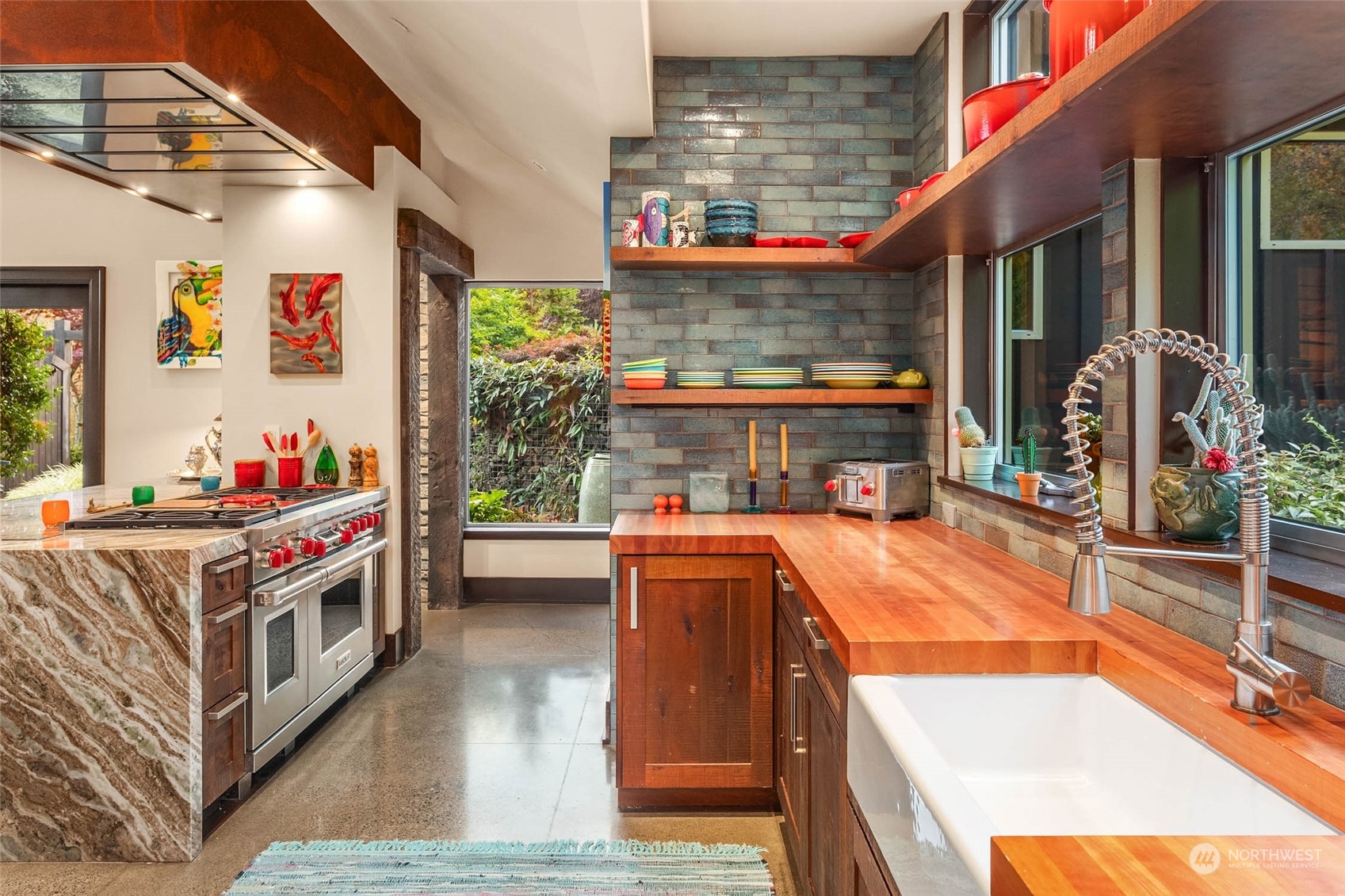 10618 Northeast 155th Place Bothell, WA 98011 - Photo 22 of 40 a utility room with stainless steel appliances kitchen island granite countertop a stove and a refrigerator