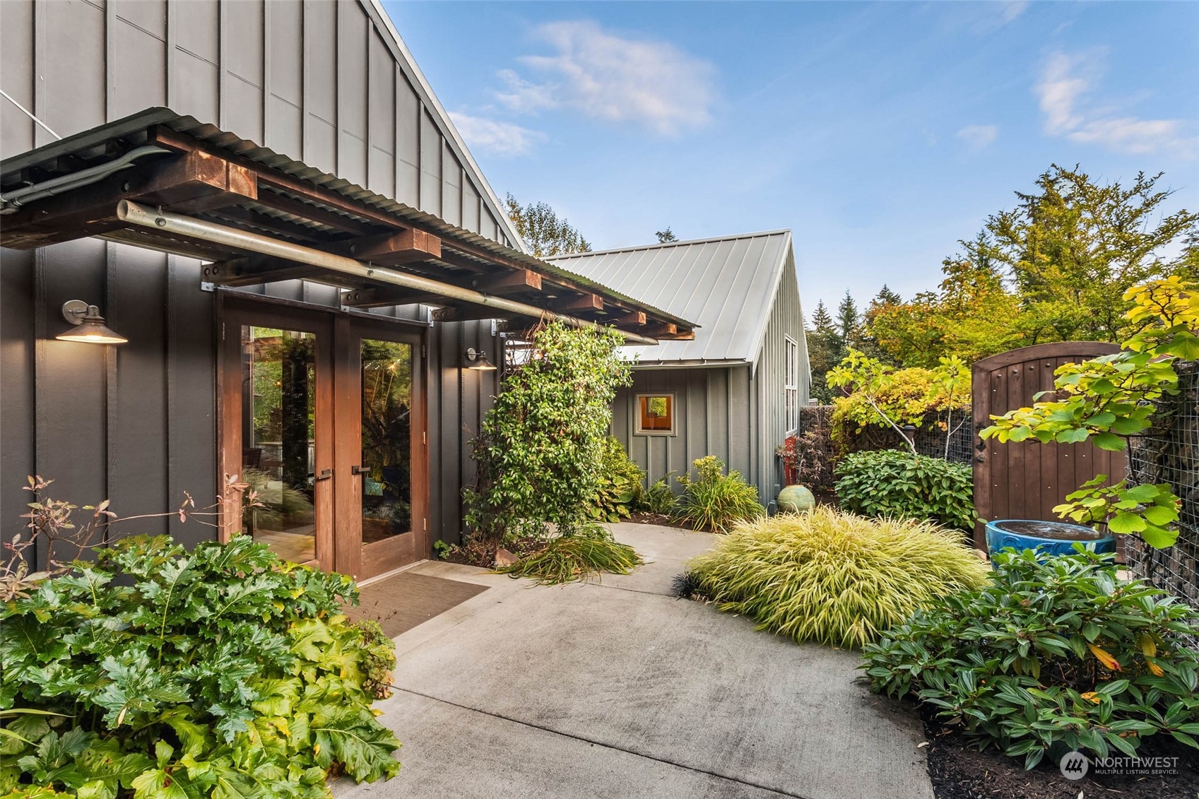 10618 Northeast 155th Place Bothell, WA 98011 - Photo 3 of 40 a backyard of a house with flower plants