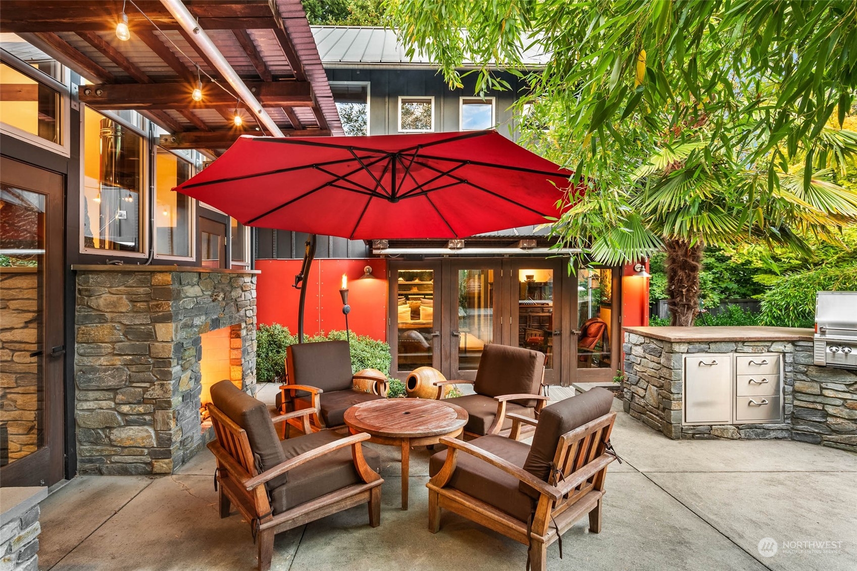 10618 Northeast 155th Place Bothell, WA 98011 - Photo 6 of 40 a view of a patio with couches and table under an umbrella