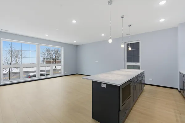 a kitchen with a stove a counter top space and a sink