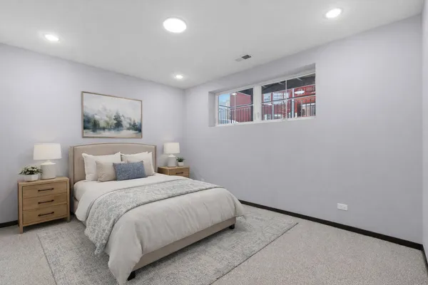 a bedroom with a bed and a painting