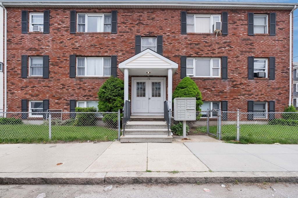 70 North Court Street, Unit F Fall River, MA 02720 - Photo 18 of 20 a front view of a house with a garden and plants