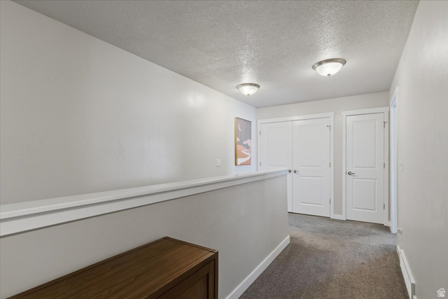 370 West Knights Lane Layton, UT 84041 - Photo 18 of 31 Hallway featuring two-panel interior doors, neutral-toned carpeting, and semi-flush mount ceiling lighting