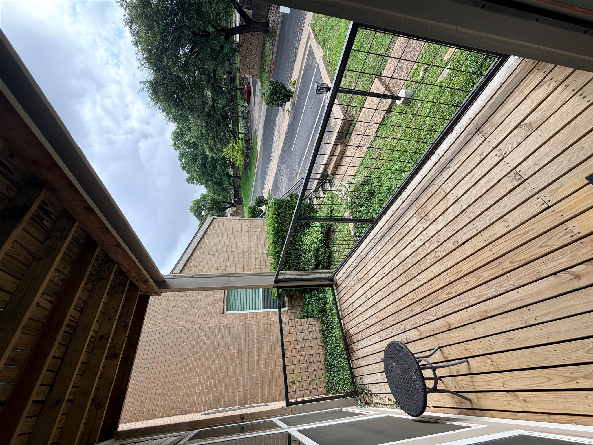 6600 Valleyside Road, Unit D20 Austin, TX 78731 - Photo 5 of 14 An inviting private deck overlooks verdant landscaping and the neighborhood street.