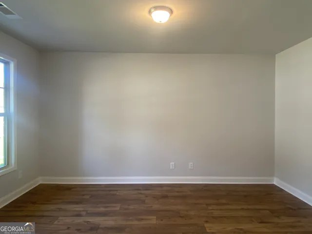 wooden floor in an empty room with a fireplace