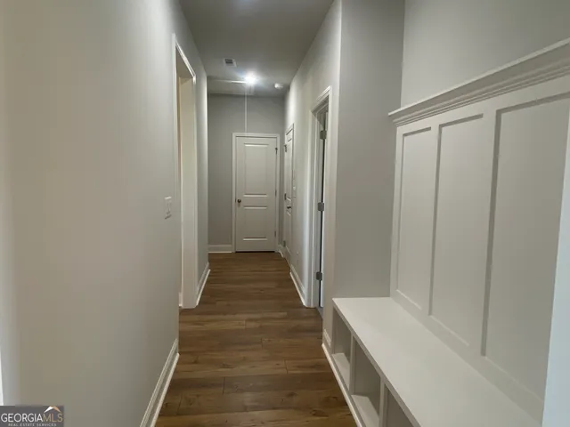 a view of a hallway with wooden floor