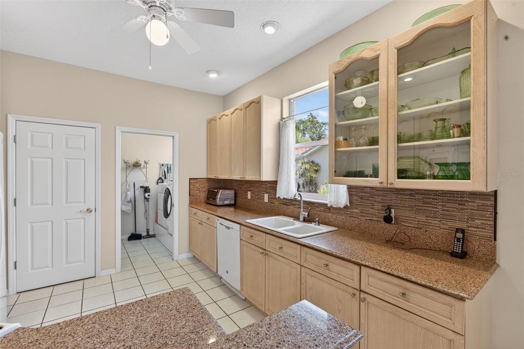 4266 Summertree Road Venice, FL 34293 - Photo 14 of 64 a kitchen with a sink stainless steel appliances cabinets and a counter top space