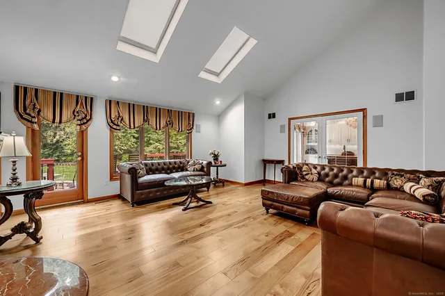 a living room with furniture a couch and a window