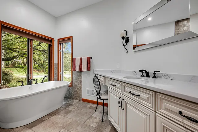 a view of a bedroom with furniture and windows