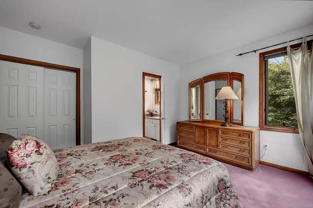 a bedroom with a large bed and a window