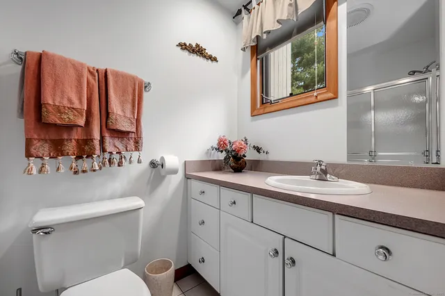 a bathroom with a sink vanity and mirror