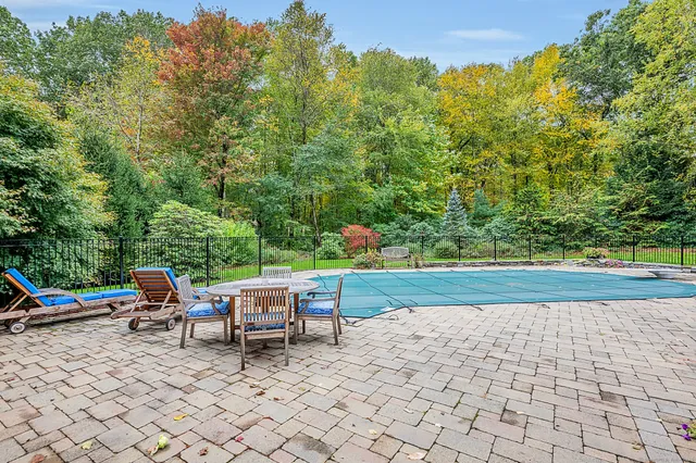 an aerial view of a house with yard swimming pool and outdoor seating
