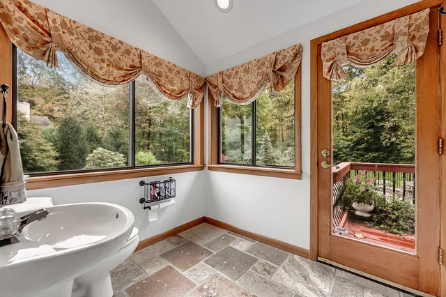 a backyard of a house with a yard and outdoor seating