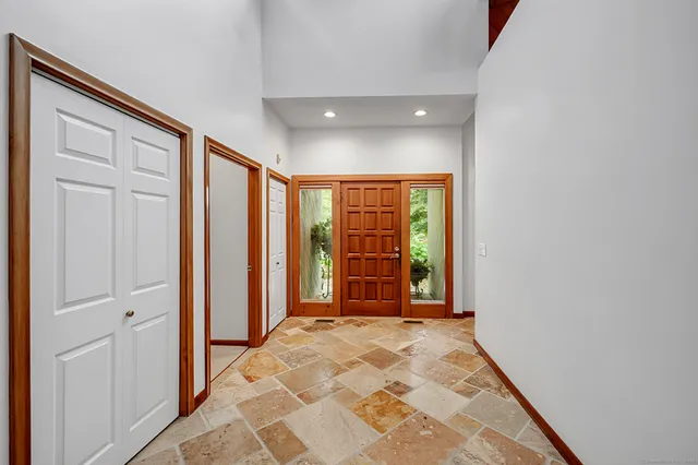 a large kitchen with a large counter top space appliances and cabinets