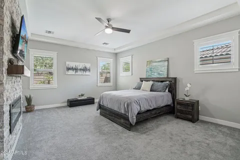 a spacious bedroom with a bed and a flat screen tv