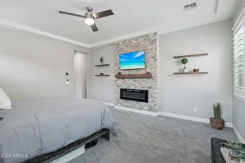 a spacious bedroom with a bed and a fireplace