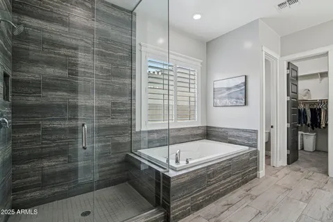 a bathroom with a tub a window and a shower