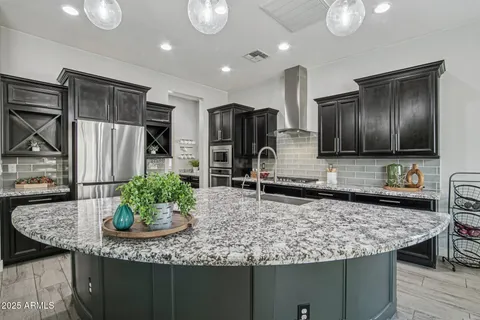 a kitchen with stainless steel appliances kitchen island granite countertop a granite counter tops and wooden cabinets