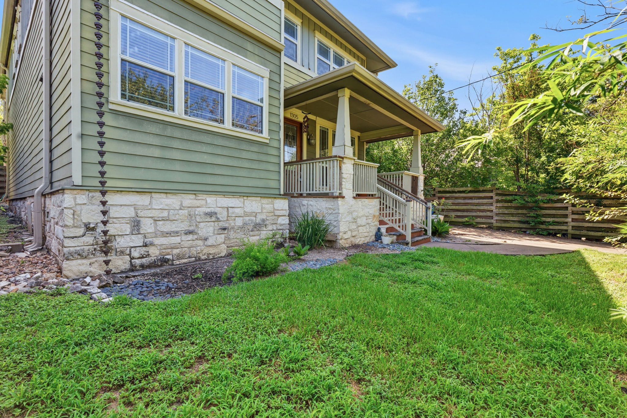 1305 Cometa Street Austin, TX 78721 - Photo 27 of 28 A welcoming covered porch and mature landscaping enhance this charming home's curb appeal.