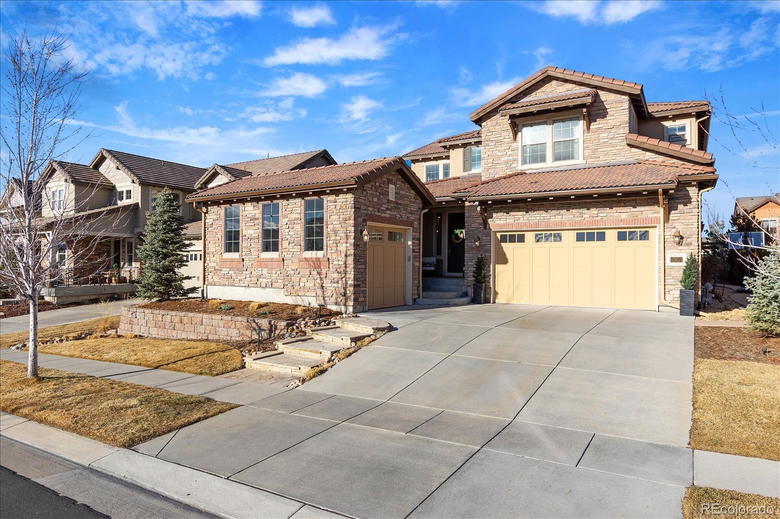 10654 Sundial Rim Road Highlands Ranch, CO 80126 - Photo 1 of 40 a front view of a house with garden