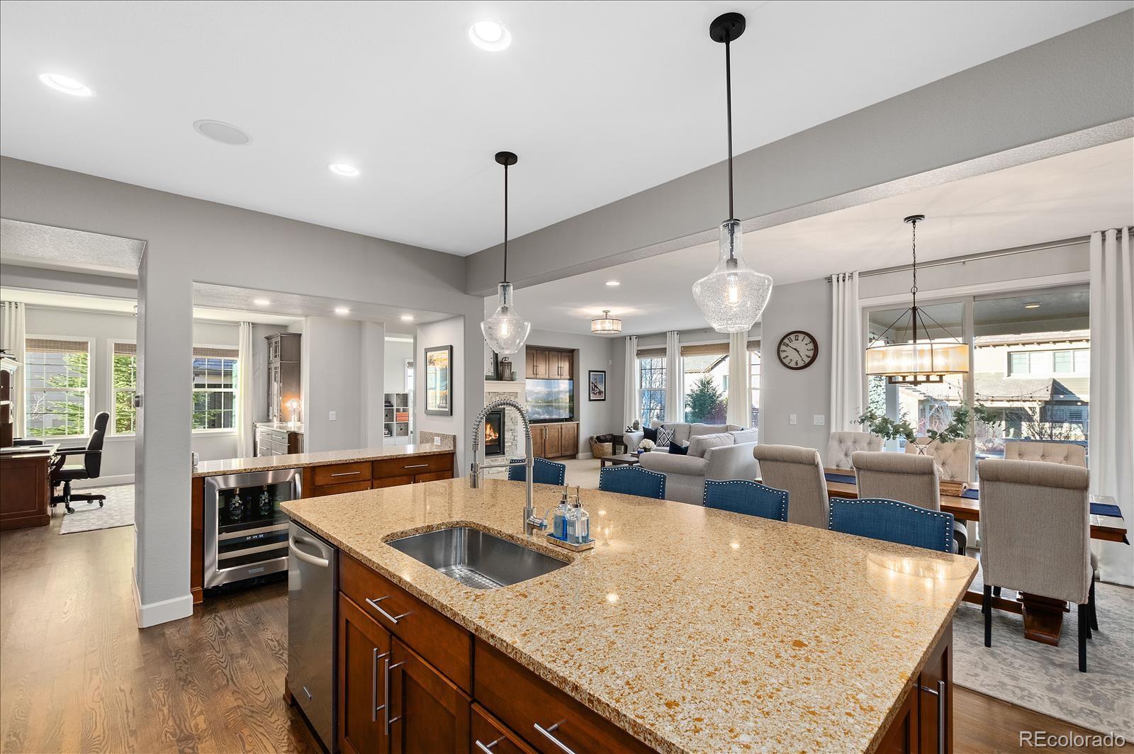 10654 Sundial Rim Road Highlands Ranch, CO 80126 - Photo 11 of 40 a kitchen with granite countertop a sink counter top space and living room view