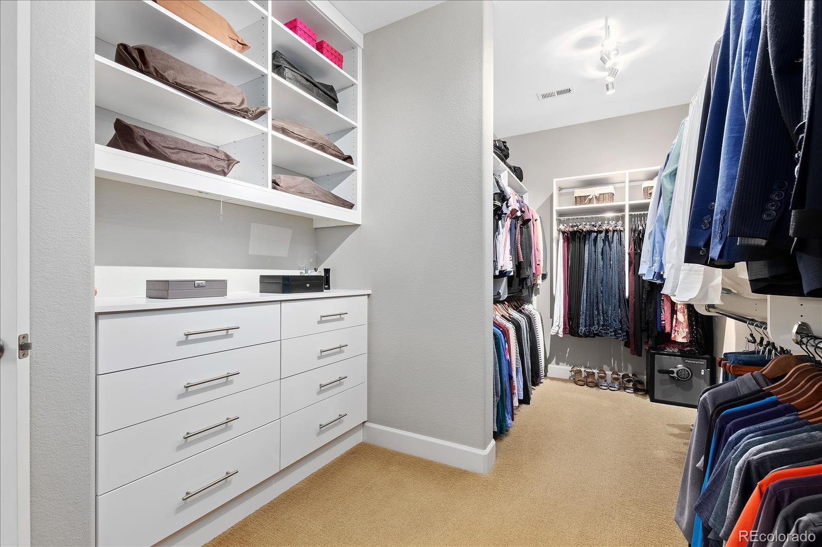10654 Sundial Rim Road Highlands Ranch, CO 80126 - Photo 18 of 40 a view of walk in closet with clothes and shoes