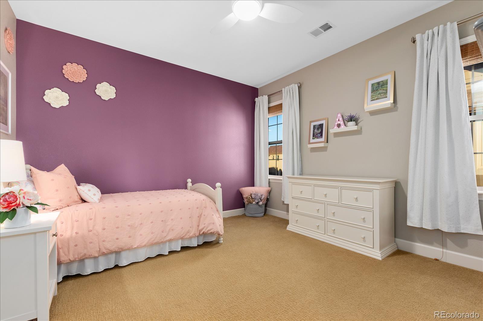 10654 Sundial Rim Road Highlands Ranch, CO 80126 - Photo 19 of 40 a bedroom with a bed and furniture