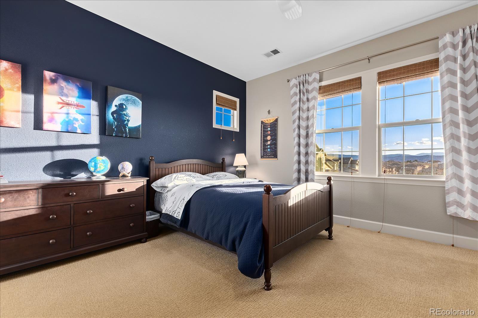 10654 Sundial Rim Road Highlands Ranch, CO 80126 - Photo 20 of 40 a bedroom with a bed and window