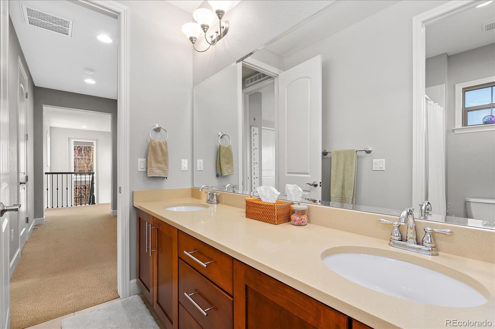 10654 Sundial Rim Road Highlands Ranch, CO 80126 - Photo 21 of 40 a bathroom with a sink double vanity and a mirror