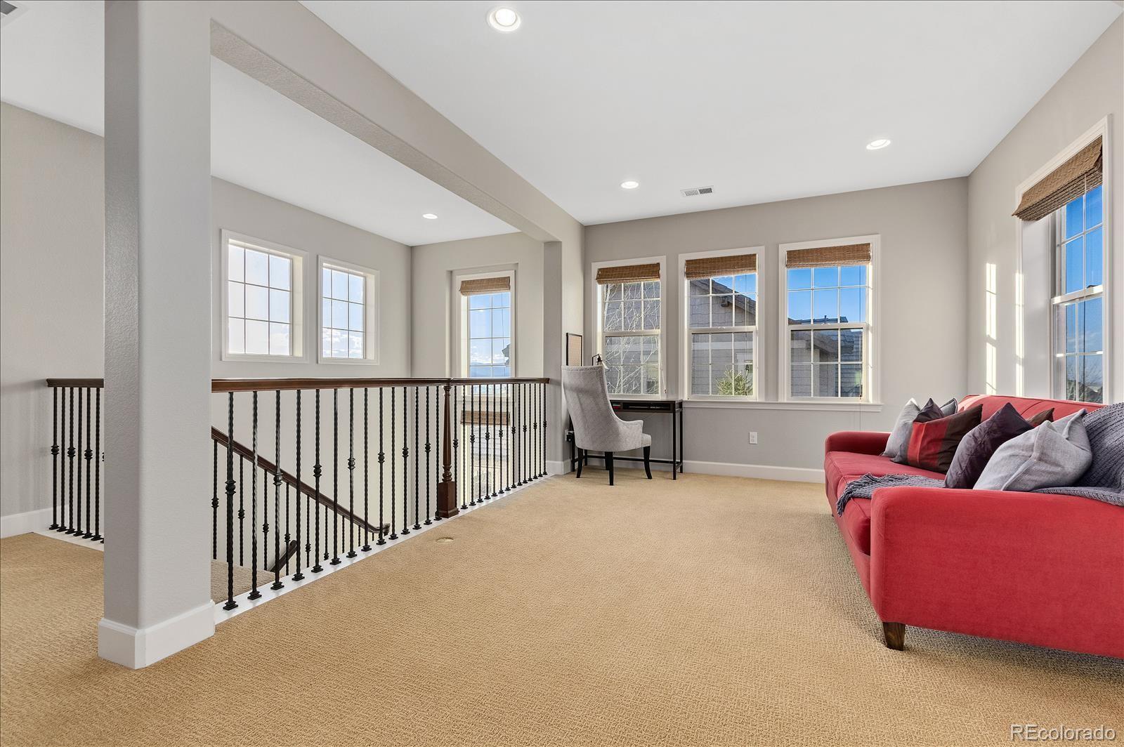10654 Sundial Rim Road Highlands Ranch, CO 80126 - Photo 22 of 40 a living room with furniture and windows