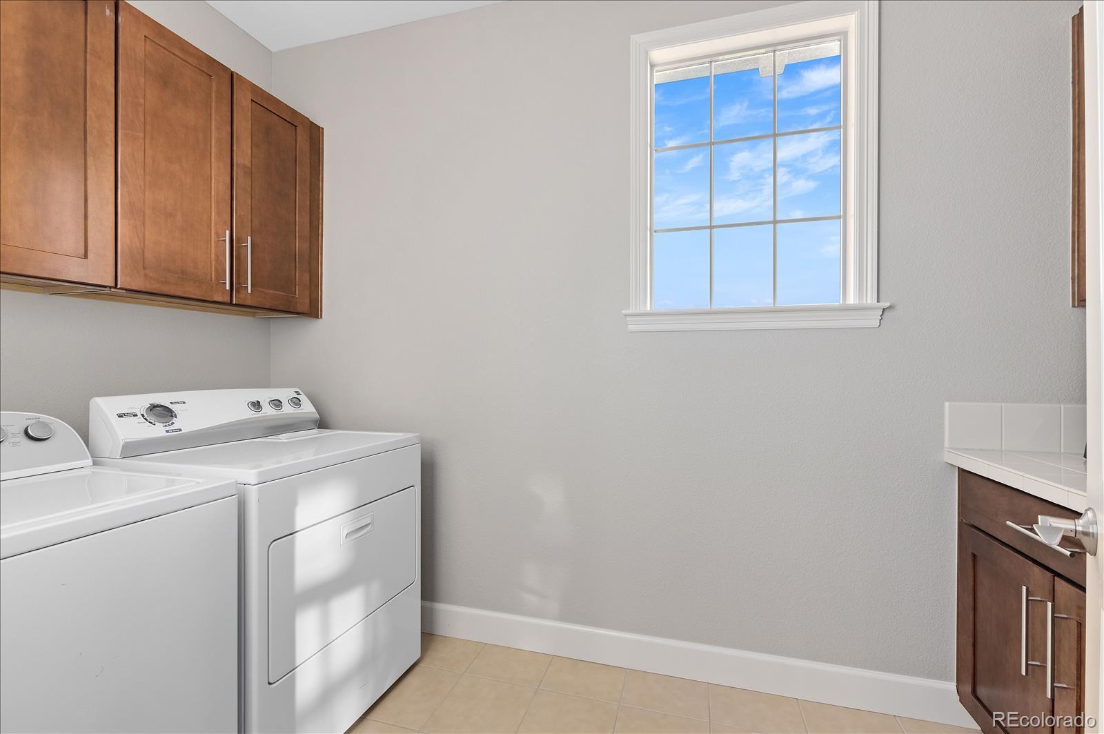 10654 Sundial Rim Road Highlands Ranch, CO 80126 - Photo 23 of 40 a utility room with dryer and washer