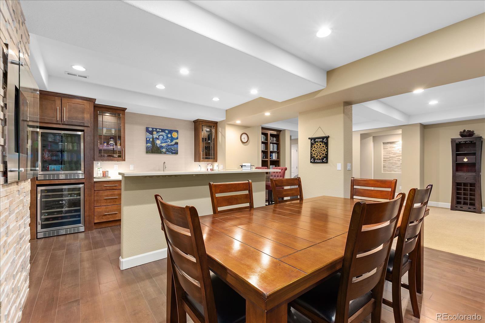 10654 Sundial Rim Road Highlands Ranch, CO 80126 - Photo 25 of 40 a dining room with furniture and wooden floor