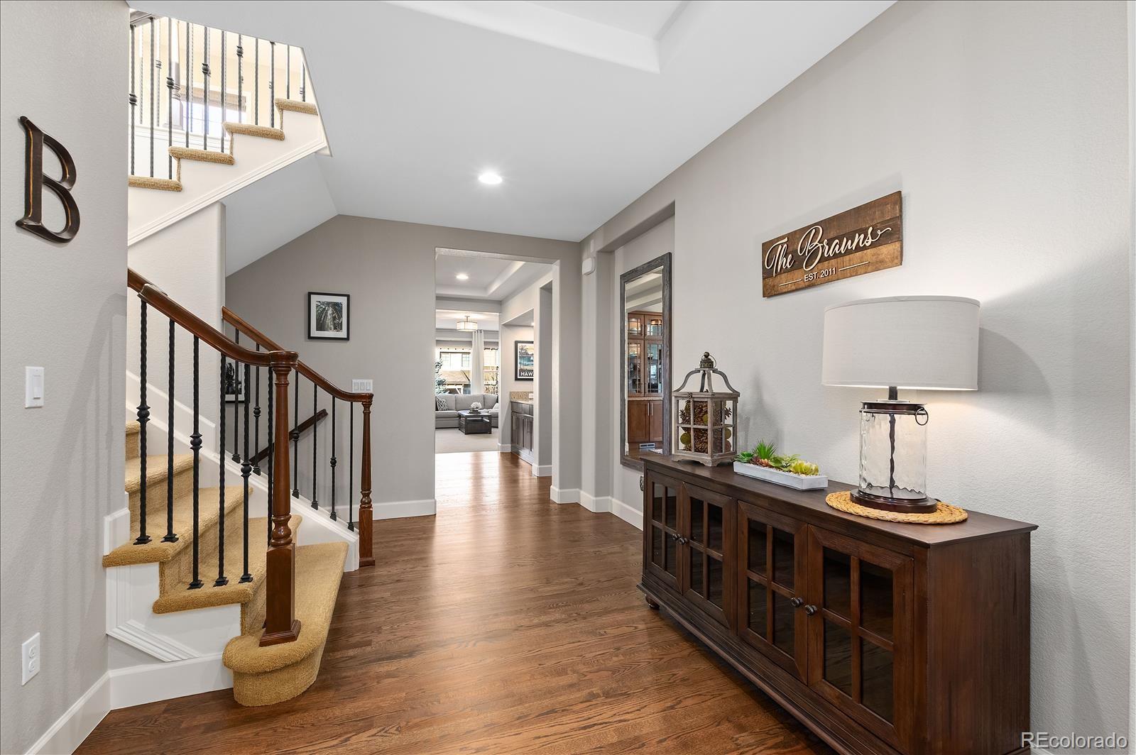 10654 Sundial Rim Road Highlands Ranch, CO 80126 - Photo 3 of 40 a view of an entryway with wooden floor