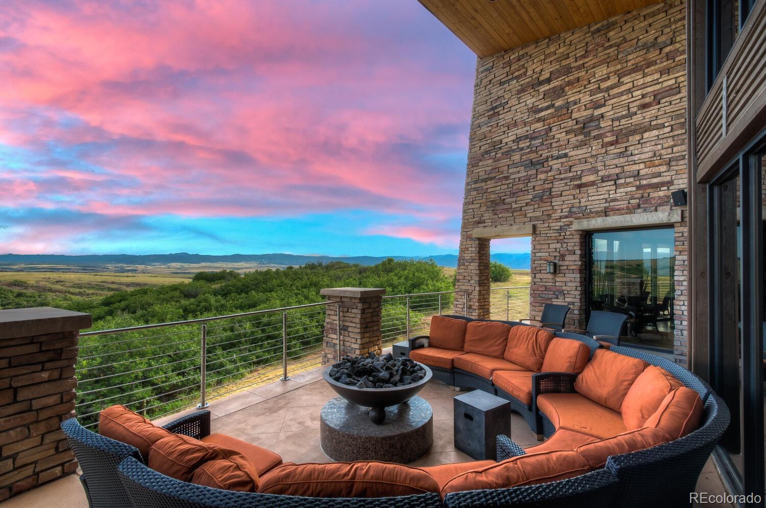 10654 Sundial Rim Road Highlands Ranch, CO 80126 - Photo 38 of 40 a view of a patio with couches chairs dining table and chairs