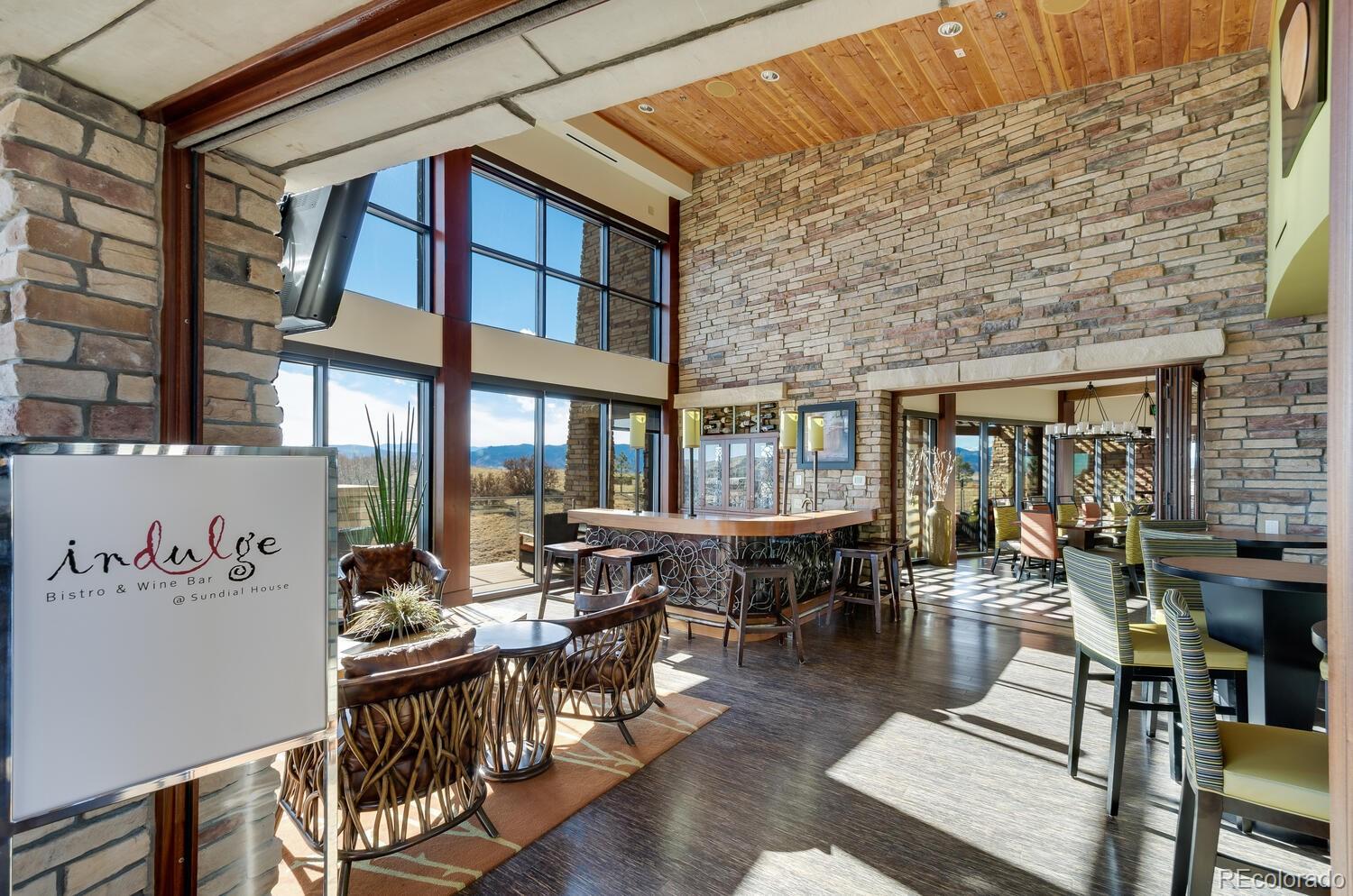 10654 Sundial Rim Road Highlands Ranch, CO 80126 - Photo 39 of 40 a view of a patio with table and chairs and floor to ceiling window