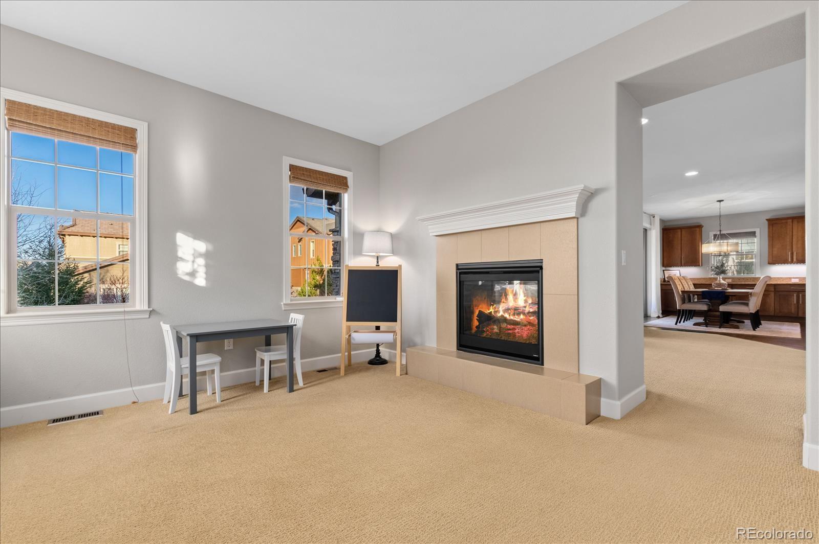 10654 Sundial Rim Road Highlands Ranch, CO 80126 - Photo 7 of 40 a view of a livingroom with furniture and a fireplace