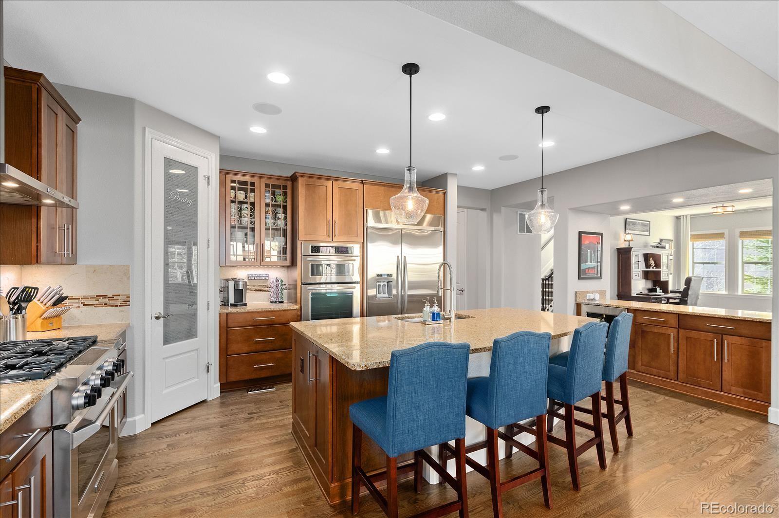 10654 Sundial Rim Road Highlands Ranch, CO 80126 - Photo 9 of 40 a large kitchen with a table and chairs